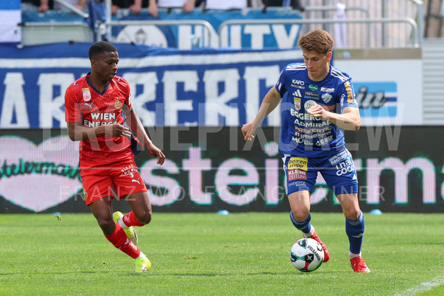 TSV Egger Glas Hartberg vs SK Rapid Wien – Championship Group    | Hartberg, Austria, 19.Apr.26 - SOCCER - ADMIRAL Bundesliga, TSV Egger Glas Hartberg vs SK Rapid Wien. The image shows Romeo Amane (SK Rapid Wien) and Marco Hoffmann (Hartberg). 