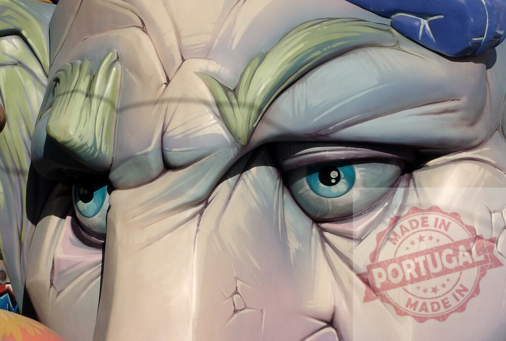 Fallas festival monument showing a giant figure with blue eyes | Detail of a Fallas ninot sculpture with a serious expression and blue eyes - Realized with Pictrs.com