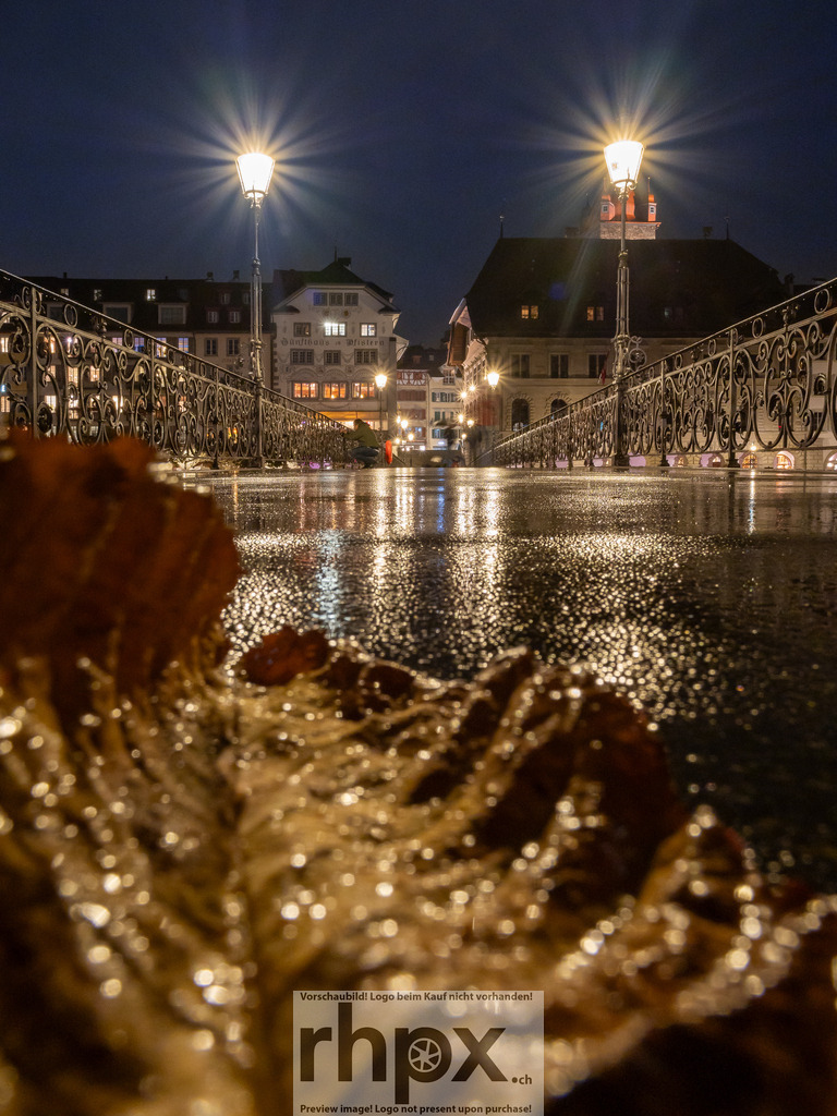 Nachtaufnahme auf der Reussbrücke in Luzern | Nachtaufnahme auf der Reussbrücke in Luzern, im Vordergrund glänzendes Herbstlaub. - Realisiert mit Pictrs.com