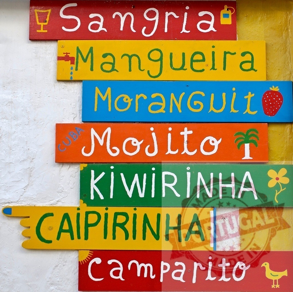 Colorful handmade wood sign displaying cocktail menu drinks | Hand painted wooden planks forming a vibrant bar menu with popular cocktail names - Realized with Pictrs.com