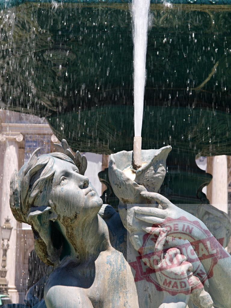 Rossio fountain statue spraying water in Lisbon, Portugal | Bronze statue of a mythological figure holding a shell, spraying water in a fountain - Realized with Pictrs.com
