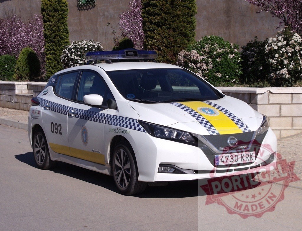 Nissan Leaf electric police car patrolling in Spain | Nissan Leaf electric patrol car on a street, representing sustainable urban law enforcement - Realized with Pictrs.com