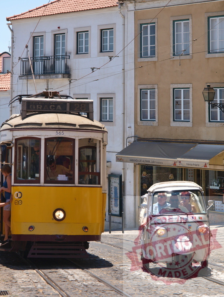 Yellow tram passing tuk tuk in Lisbon, Portugal | Tourists enjoying a ride on a tuk tuk passing a yellow tram in Lisbon - Realized with Pictrs.com