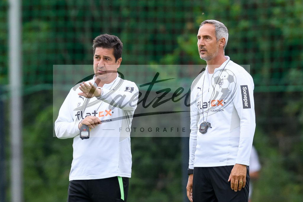 TRABMG20210719_014 | Fussball, Herren: Co-Trainer Christian Peintinger (Borussia Moenchengladbach) und Trainer Adi Huetter (Borussia Moenchengladbach) schauen beim Training von Borussia Moenchengladbach waehrend des Trainingslagers auf dem Trainingsplatz am Hotel Klosterpforte am 19.07.2021 in Harsewinkel, Deutschland. - Realisiert mit Pictrs.com