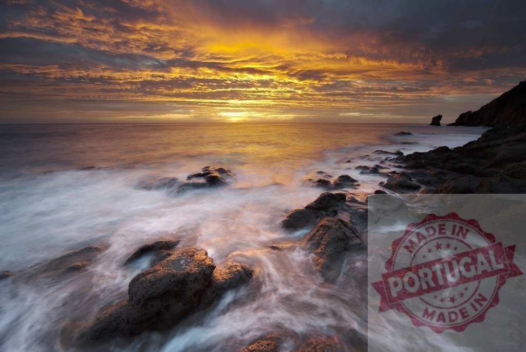 Vibrant sunset sky over rolling ocean waves and rocky coastline | Colorful sunset painting the sky and ocean with long exposure waves washing over dark rocks - Realized with Pictrs.com