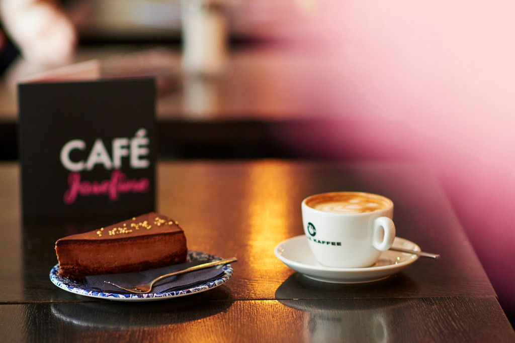 Cafe Josefine | WIen, Austria - February 13, 2018: Cafe Josefine; Blick in das Cafe-auf dem Tisch stehend eine Chocolate de Luxe Torte mit einer Tasse Felix Kaffee und einer Speisekarte. - Realisiert mit Pictrs.com