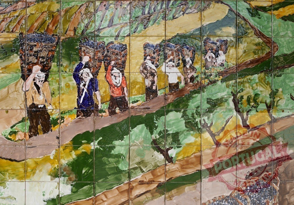 Azulejo tile mural depicting grape harvesters and vineyard | People harvesting grapes in a vineyard, carrying baskets on their heads in a traditional tile mural - Realized with Pictrs.com