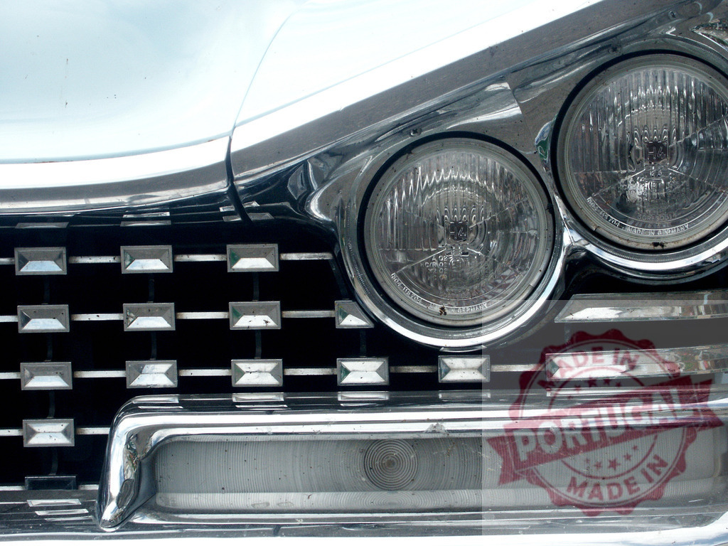 Shiny chrome grill and headlights reflecting light on classic Buick | Chrome grill and headlights reflecting light on classic Buick parked on the street - Realized with Pictrs.com