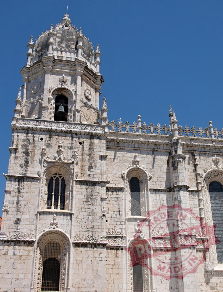 Jeronimos Monastery church tower Manueline architecture in Lisbon. Lisbon - Portugal | Jeronimos Monastery featuring historic church stone facade against a clear blue sky - Realisiert mit Pictrs.com