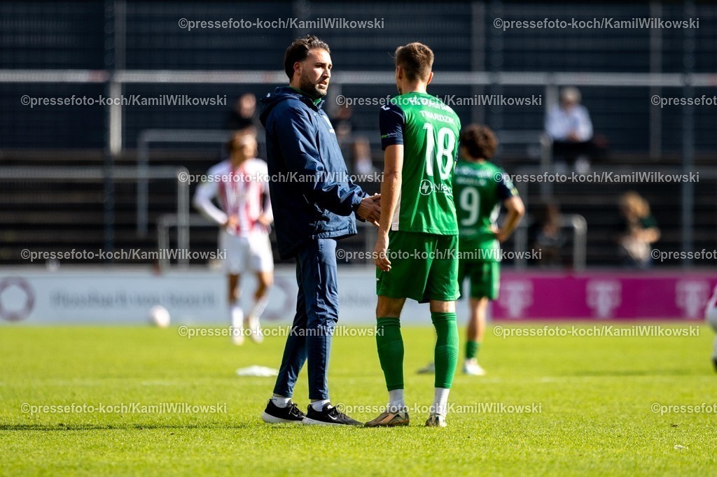 xKWI27092501031 | 27.09.2025, xkwix, Fußball, Regionalliga West, 1. FC Köln U23 - FC Gütersloh, Geißbockheim Franz-Kremer-Stadion, Julian Hesse (Trainer FC Gütersloh) und Patrik Twardzik (FC Gütersloh #18) klatschen nach dem Spiel ab