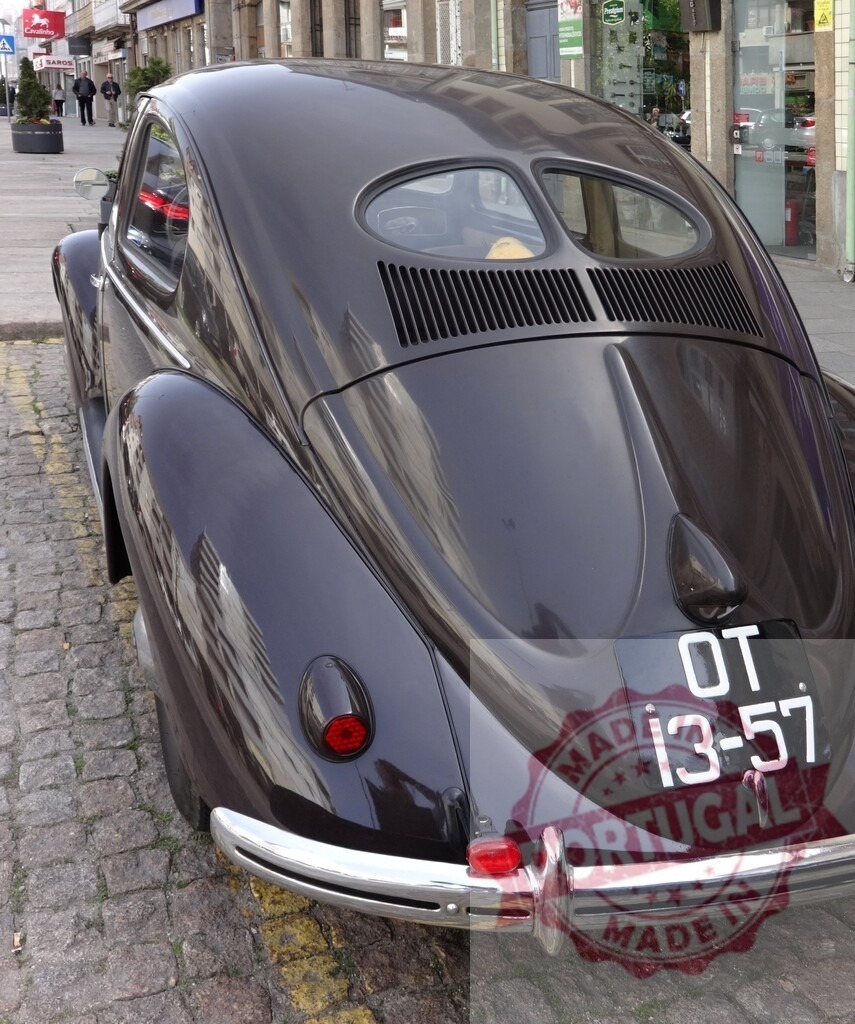Rear view of classic Volkswagen Beetle parked on cobblestone street | Classic Volkswagen Beetle showing its iconic rear design and split rear window, parked on a cobblestone street - Realized with Pictrs.com