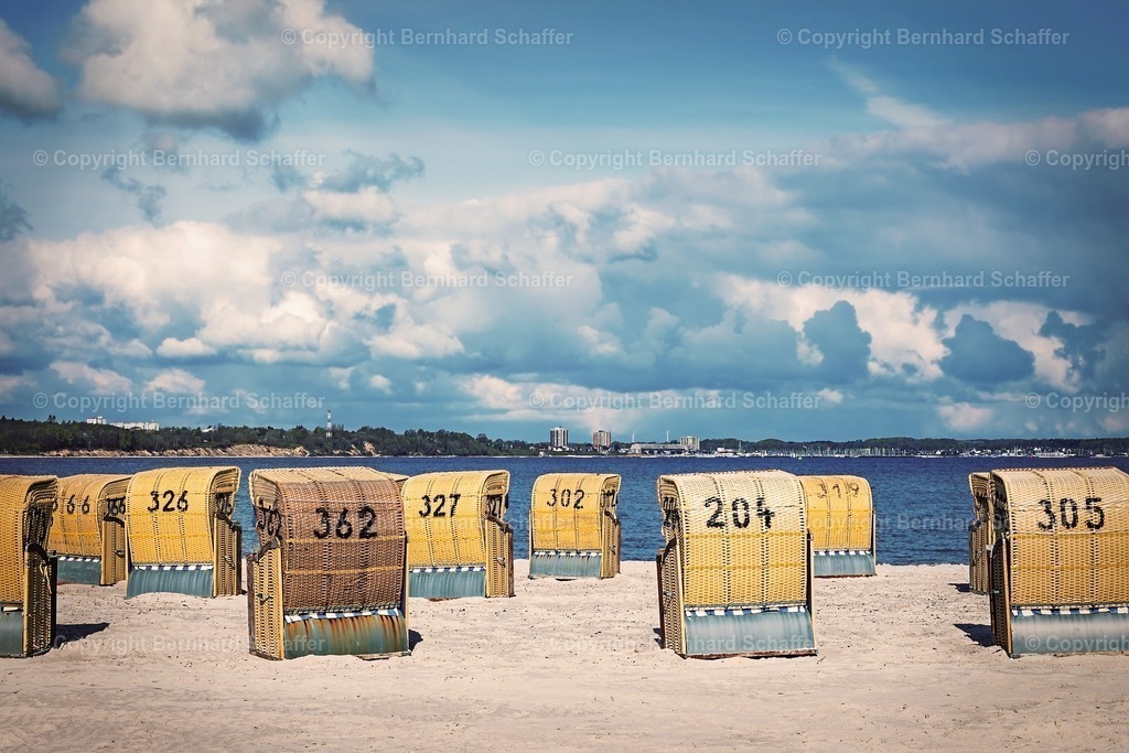 Wolken über dem Strand | Einige Strandkörbe an einem Sandstrand der Ostsee in der Kieler Förde bei dramatischem Wetter. - Realisiert mit Pictrs.com