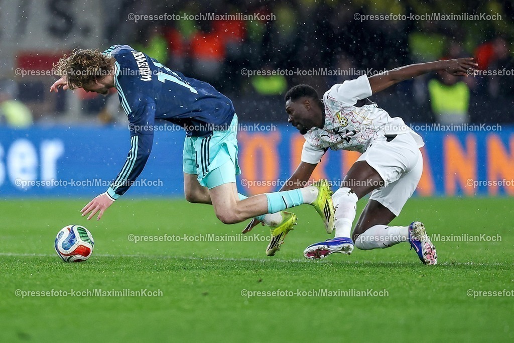 DFB30032600071 | 30.03.2026, Fußball, Länderspiel, Deutschland - Ghana, MHP-Arena (Stuttgart), Saison 2025 2026: Nick Woltemade (GER #11) im Zweikampf gegen  Alexander Djiku (Ghana #23)  DFB regulations prohibit any use of photographs as image sequences and or quasi-video.
