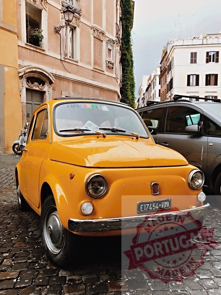 Classic yellow Fiat 500 parked on cobblestone street in Rome | Shiny yellow Fiat 500 parked in Rome, Italy, showcasing iconic Italian car design and urban charm - Realisiert mit Pictrs.com