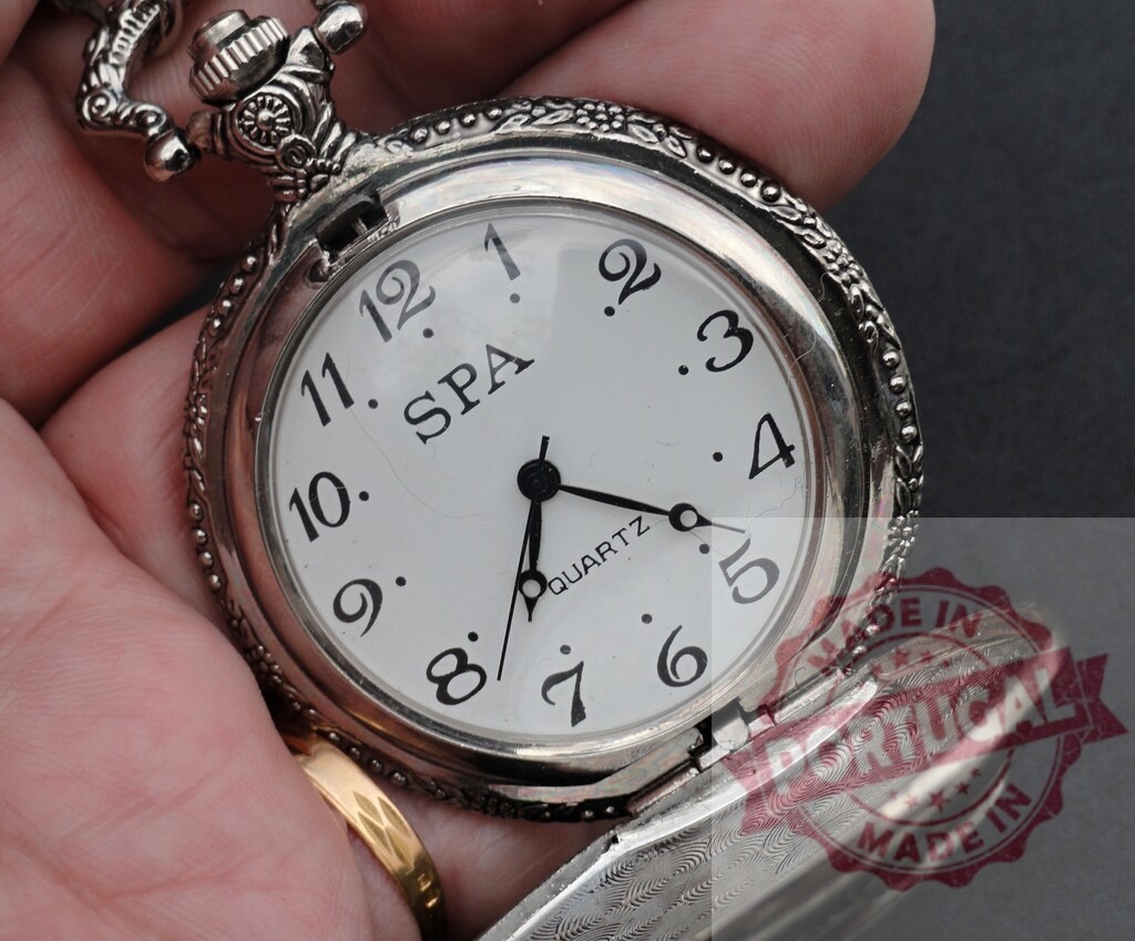 Hand holding vintage silver quartz pocket watch | Hand holding an antique style silver pocket watch with a white dial - Realized with Pictrs.com