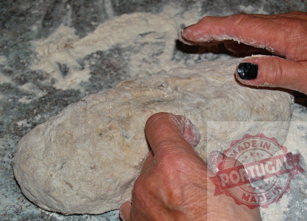 Hands kneading homemade dough on a floured surface | Hands kneading fresh dough, preparing it for baking - Realisiert mit Pictrs.com