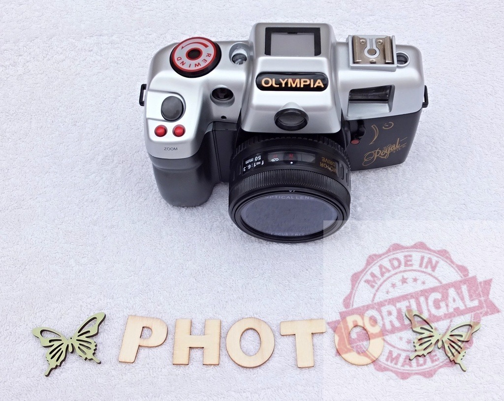 Olympia camera and wooden PHOTO word with butterflies | Olympia film camera with wooden letters spelling PHOTO and decorative butterflies - Realisiert mit Pictrs.com