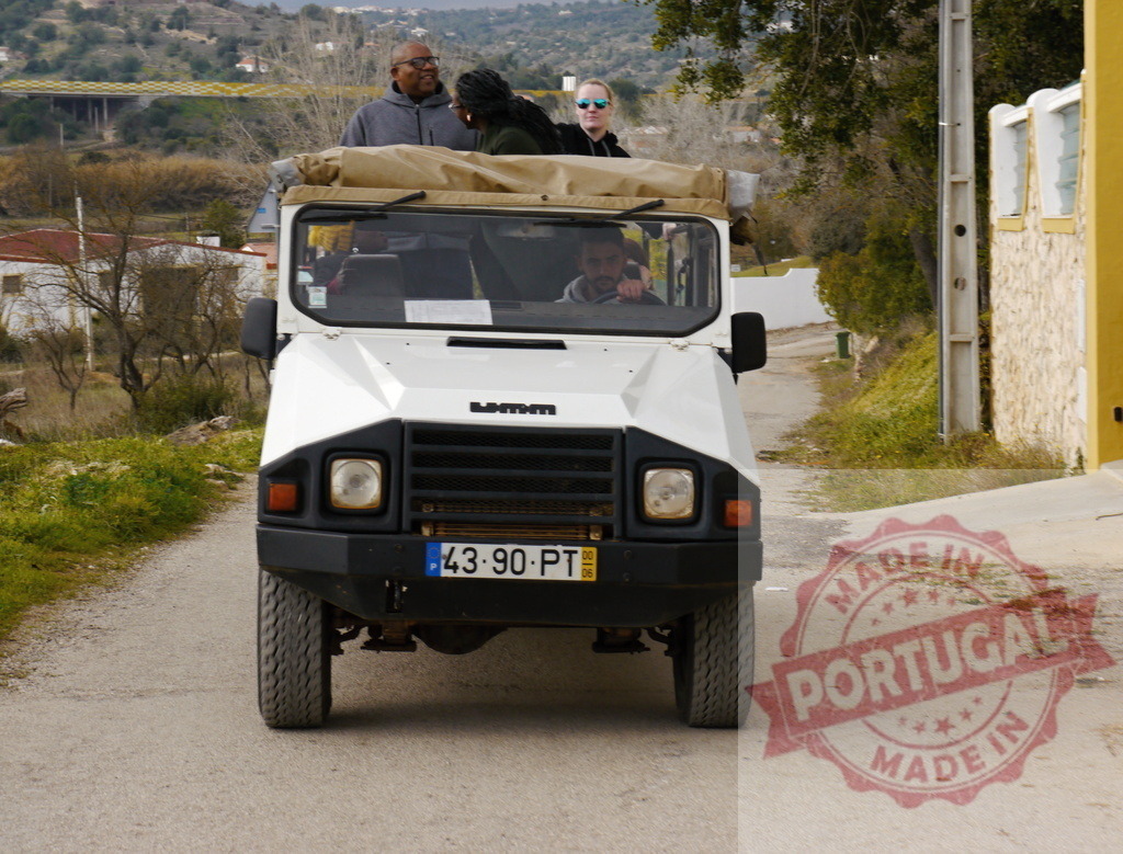 Tourists enjoying jeep safari adventure in rural Portugal | People riding an UMM Alter II off-road vehicle during a safari tour in a village - Realisiert mit Pictrs.com