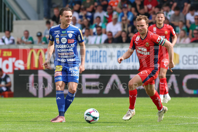 TSV Egger Glas Hartberg vs SK Rapid Wien – Championship Group    | Hartberg, Austria, 19.Apr.26 - SOCCER - ADMIRAL Bundesliga, TSV Egger Glas Hartberg vs SK Rapid Wien. The image shows Lukas Fridrikas (Hartberg) and Matthias Seidl (SK Rapid Wien). 