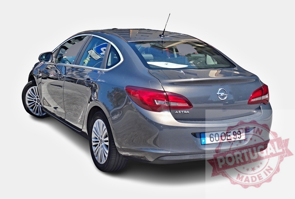 Opel Astra sedan car parked on white background | Modern gray Opel Astra sedan car parked on a white background, showcasing its sleek design - Realisiert mit Pictrs.com