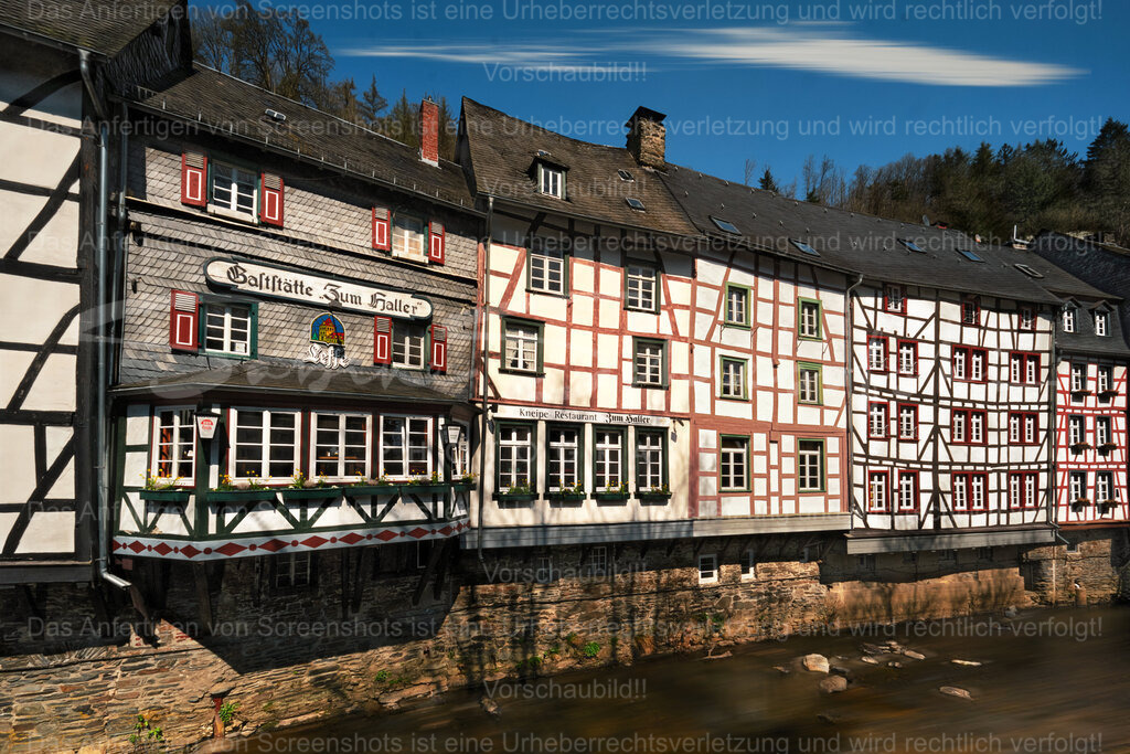 Es wird Frühling in Monschau | Die Gaststätte Zum Haller ist in einer Reihe anderer Fachwerkhäuser in Monschau zu sehen. Im Vordergrund fließt die Rur - Realisiert mit Pictrs.com