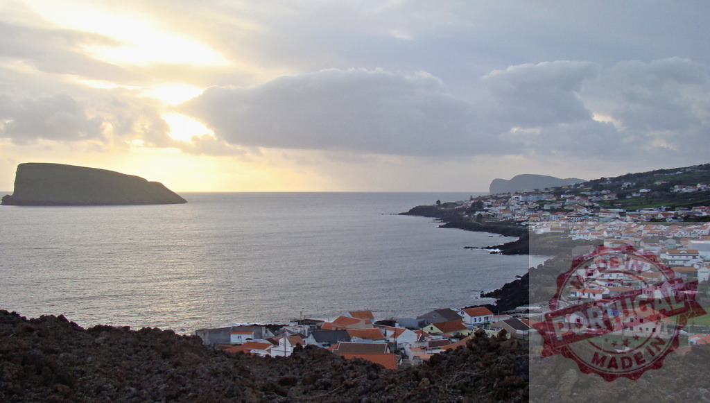 Mosteiros village coast and volcanic island at sunset | Mosteiros village showing its coastal houses and volcanic landscape with a distant island during sunset - Realized with Pictrs.com