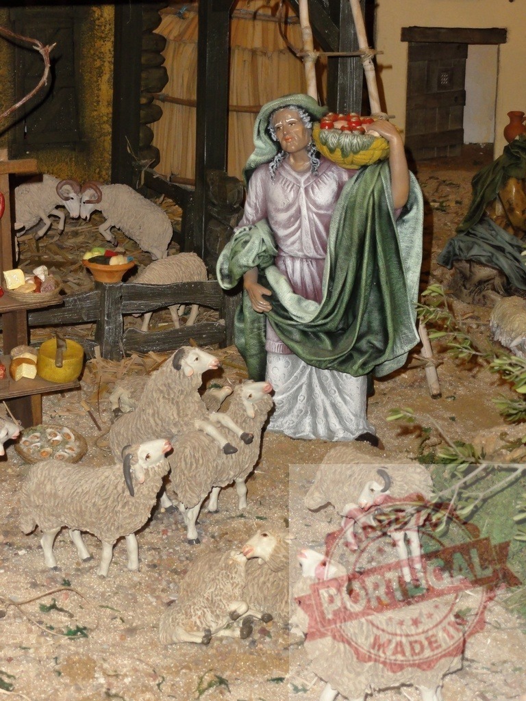 Woman carrying basket of fruits walking near sheep in stable at Christmas market | Woman carrying basket of fruits walking near sheep in stable at Christmas market - Realisiert mit Pictrs.com