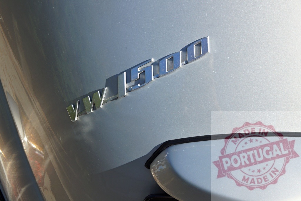 Volkswagen VW 1500 classic car emblem detail | Volkswagen VW 1500 classic car emblem on silver paint with sunlight reflection - Realized with Pictrs.com