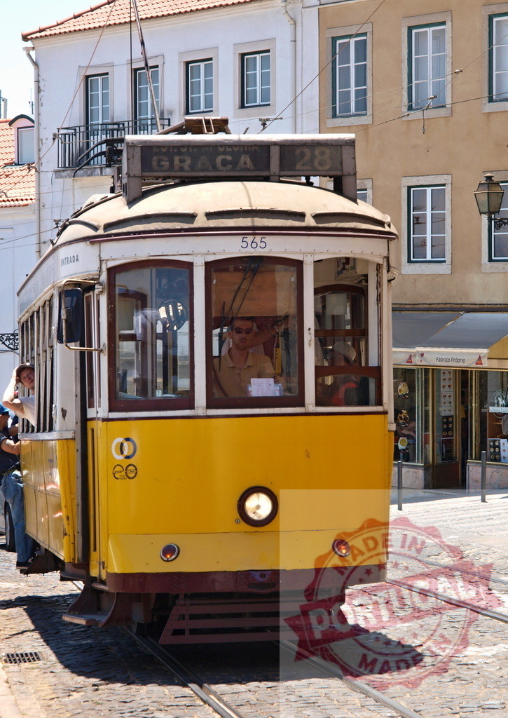 Yellow Tram Number 28 Traveling Through Lisbon, Portugal | Yellow tram number 28 moving through Lisbon's historic streets, carrying passengers and offering a glimpse of the city's charm - Realisiert mit Pictrs.com