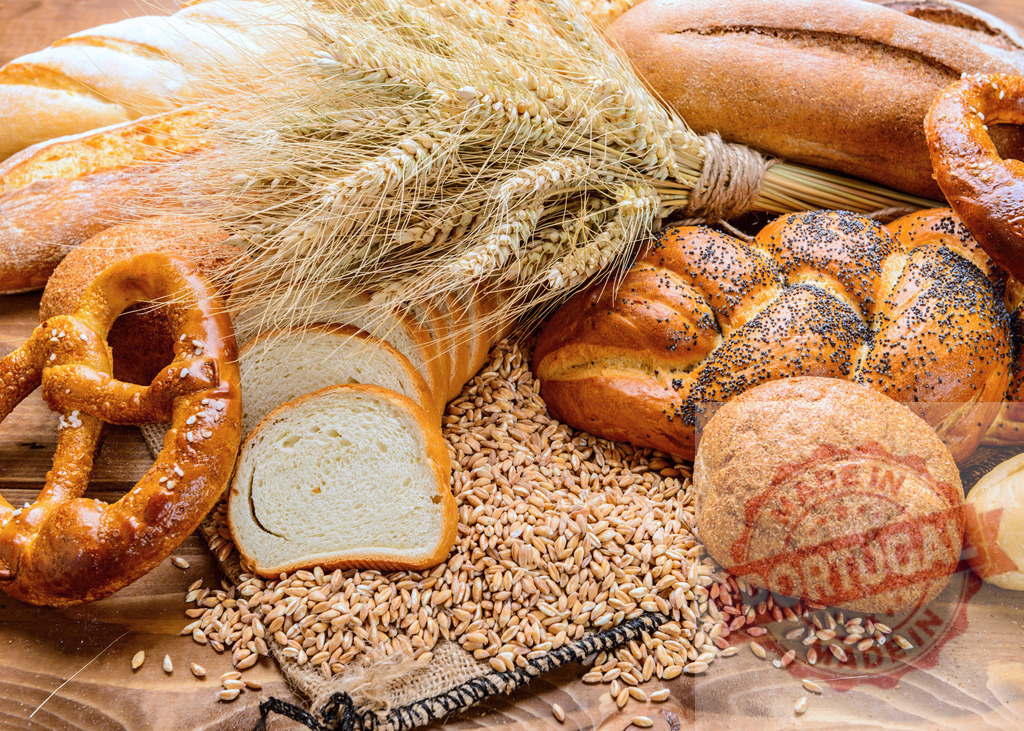 Fresh bread products with wheat grains and ears | Assortment of baked goods with wheat ears and raw grains on wooden table - Realisiert mit Pictrs.com