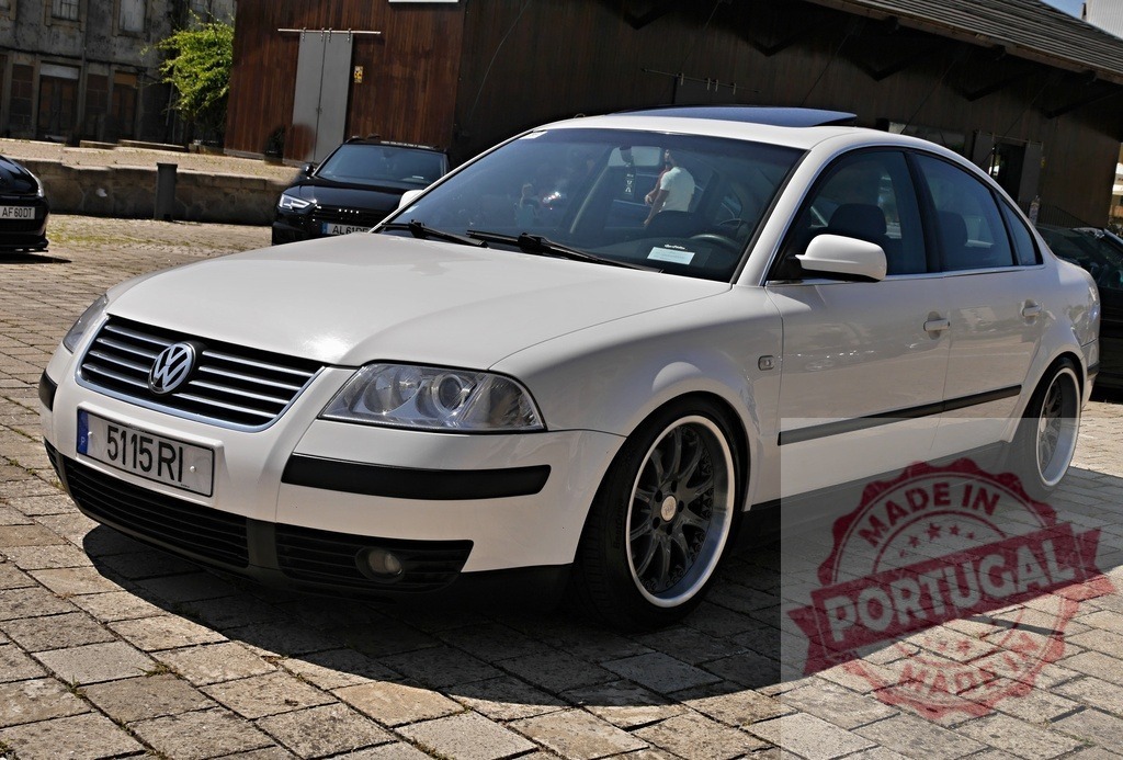 Volkswagen Passat white sedan custom alloy wheels | Volkswagen Passat B5 parked outdoors on a cobblestone pavement with dark custom wheels and sunroof - Realized with Pictrs.com