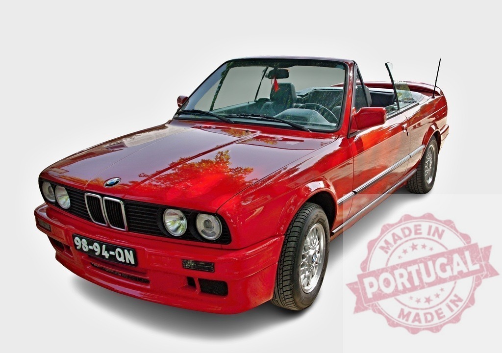 Red vintage BMW E30 convertible isolated on white | Red BMW E30 convertible car displaying classic design and open-top driving style - Realized with Pictrs.com