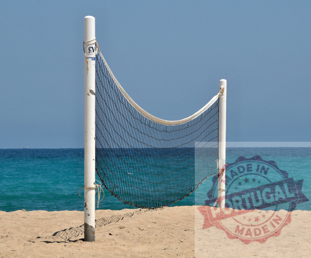 Volleyball net standing on a sandy beach facing the sea | Beach volleyball net setup on a beautiful sandy beach facing the calm turquoise sea, ready for a game - Realisiert mit Pictrs.com