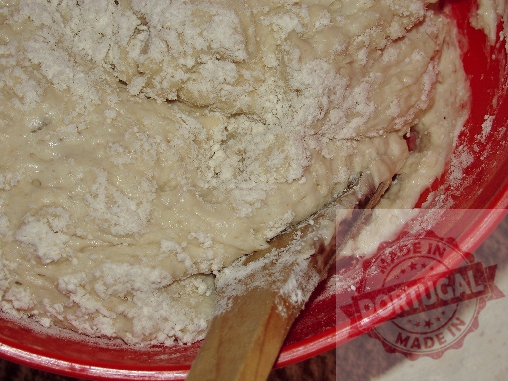Mixing bread dough with flour in red bowl | Fresh bread dough mixing with flour in a vibrant red bowl using a wooden spoon - Realized with Pictrs.com