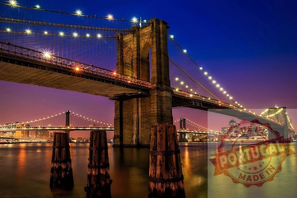 Brooklyn Bridge and Manhattan Bridge at night over East River | Brooklyn Bridge and Manhattan Bridge illuminated over the East River with the Manhattan skyline - Realized with Pictrs.com