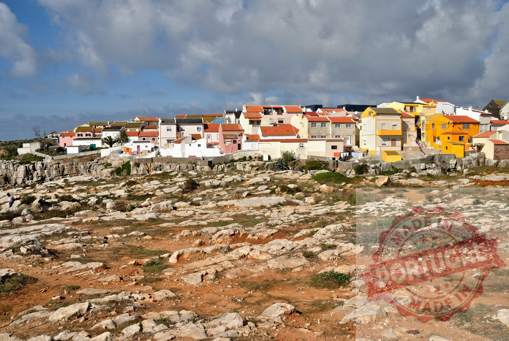 Peniche village architecture on rocky Atlantic coast. Centro - Portugal | Colorful homes lining the cliffs of a Portuguese coastal town with dramatic sky - Realized with Pictrs.com