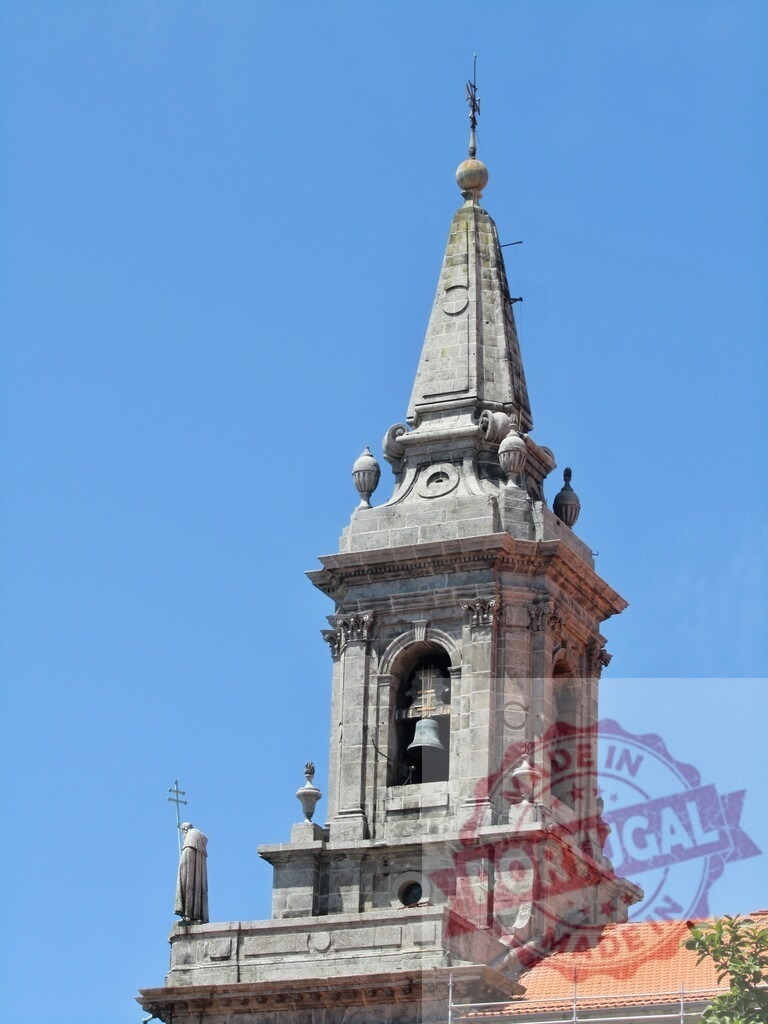 Church of the Third Order of Saint Francis bell tower, Porto. Porto - Portugal | Historic Baroque granite bell tower of a church in Porto against a clear blue sky - Realized with Pictrs.com