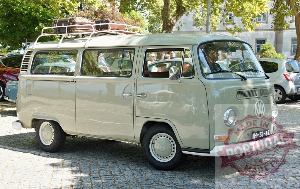 Classic Volkswagen Kombi Van parked on cobblestone street | Restored Volkswagen Kombi Type 2, iconic vintage camper van, parked in urban setting, evoking nostalgia and travel adventures - Realized with Pictrs.com