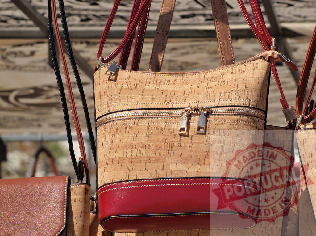 Hanging cork handbag with red base for sale | Cork handbag displaying eco-friendly material and sustainable fashion accessory - Realized with Pictrs.com