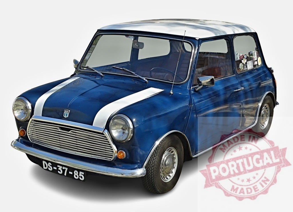 Classic blue Mini Cooper posing in a studio | Vintage Mini Cooper with white racing stripes parked against a white background, showcasing its timeless design - Realized with Pictrs.com