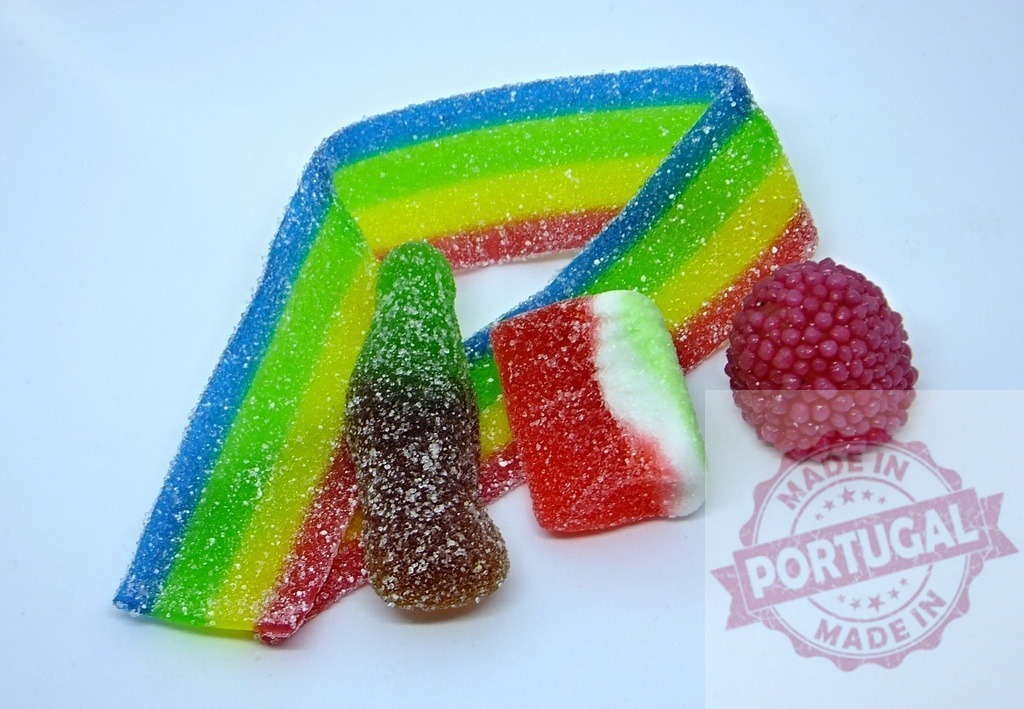 Colorful sour rainbow candy gummies and other sweets | Assorted colorful sour sugary candies including a rainbow belt, cola bottle, and fruit shapes - Realisiert mit Pictrs.com
