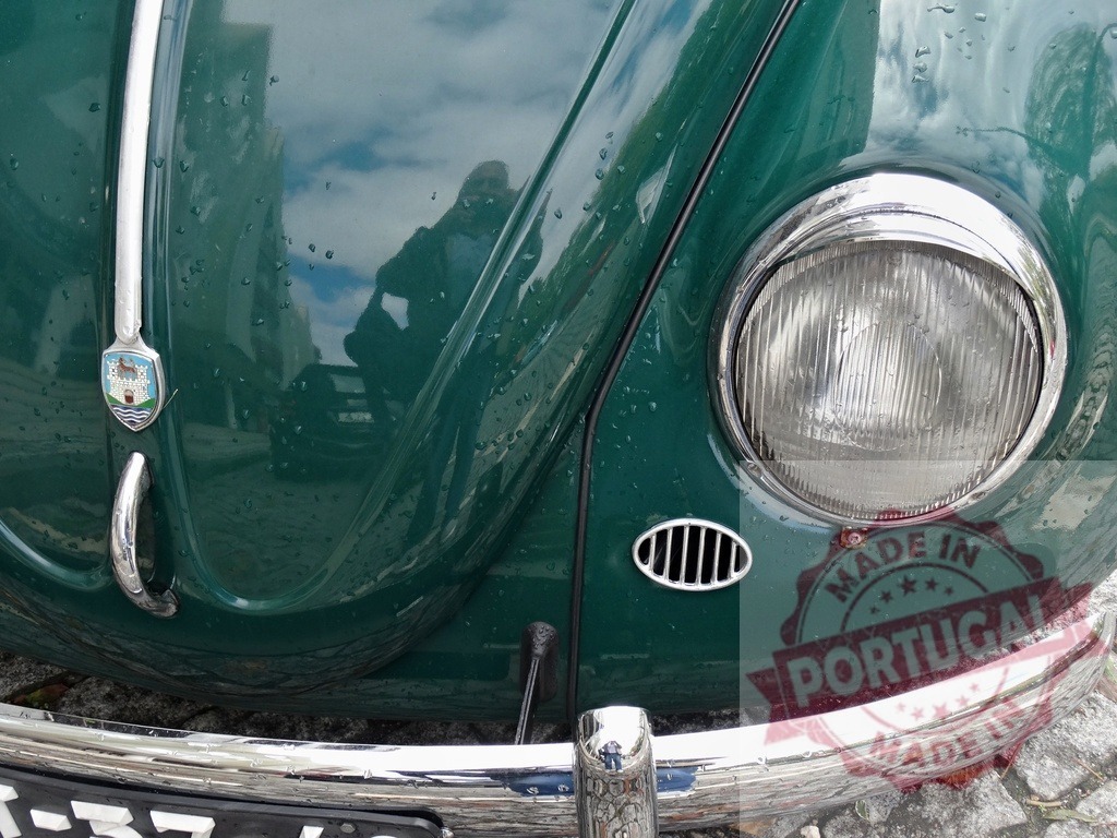 Volkswagen Beetle classic car headlight and Wolfsburg logo | Volkswagen Beetle classic car front with chrome bumper and headlight detail - Realized with Pictrs.com