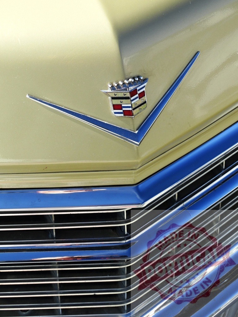 Cadillac crest emblem on vintage luxury car | Cadillac crest emblem and chrome grille on vintage luxury automobile - Realized with Pictrs.com