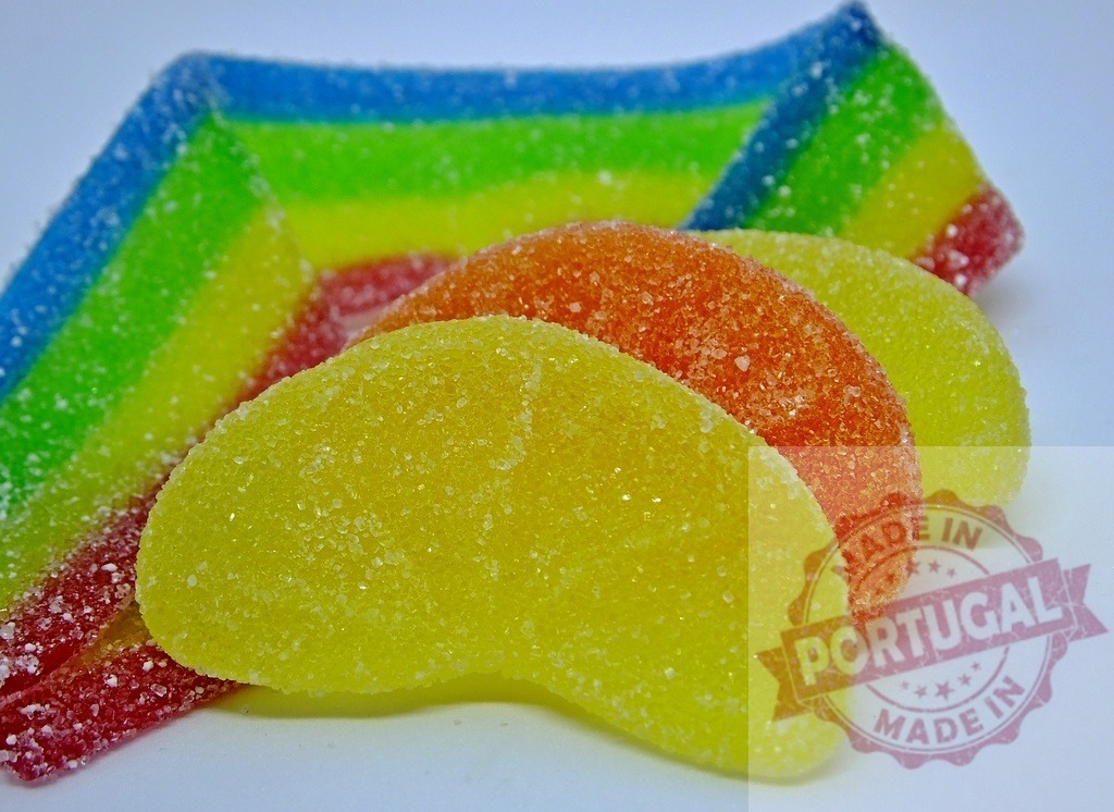 Colorful gummy candy slices and rainbow sweets | Bright sugar-coated gummy fruit slices and a rainbow sour belt creating a sweet treat - Realized with Pictrs.com