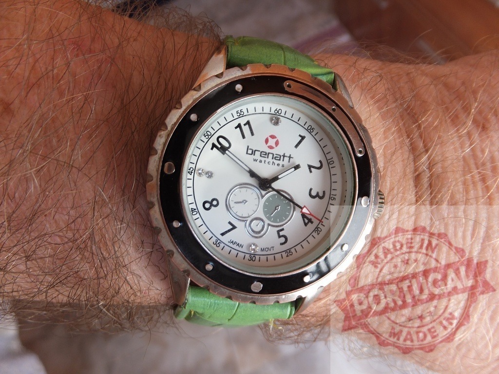 Brenatt wristwatch on hairy arm showing time | Brenatt chronograph wristwatch with a green leather strap on a man's hairy arm - Realized with Pictrs.com