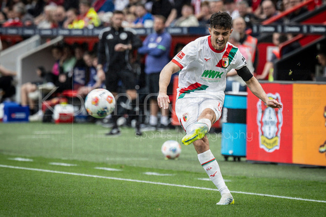 German Bundesliga, Bayer 04 Leverkusen vs. FC Augsburg, 18.04.2026 | LEVERKUSEN, GERMANY - APRIL 18, 2026 :  Dimitris Giannoulis (FC Augsburg, 13) during the German Bundesliga match on gameday 30 between Bayer 04 Leverkusen vs. FC Augsburg at BayArena on April 18, 2026 in Leverkusen, Germany. DFL REGULATIONS PROHIBIT ANY USE OF PHOTOGRAPHS AS IMAGE SEQUENCES AND/OR QUASI-VIDEO.