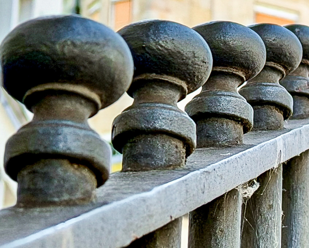Wandbild Historische Steinbalustrade - Rhythmische Architektur-Geometrie | Dieses meisterhafte Architektur-Wandbild zeigt die detailreiche Nahaufnahme einer historischen Steinbalustrade. Die kunstvoll geformten Säulenelemente faszinieren durch ihre raue Materialität, die sichtbaren Spuren der Zeit und einen hypnotischen, rhythmischen Verlauf, der eine beeindruckende visuelle Tiefe erzeugt. Fotograf Robert Steinke fängt das harmonische Wechselspiel aus Licht, Schatten und klassischer Steinmetzkunst in gestochen scharfer Premium-Qualität ein. Ein absolut zeitloser, charakterstarker Blickfang, der stilvollen Wohnräumen, Flure oder anspruchsvollen Büros eine elegante, historische Würde verleiht. Perfekt geeignet als großformatiger Premium-Kunstdruck auf edlem Alu-Dibond, Leinwand oder unter brillantem Acrylglas für eine beeindruckende Galerie-Ästhetik. - Realisiert mit Pictrs.com
