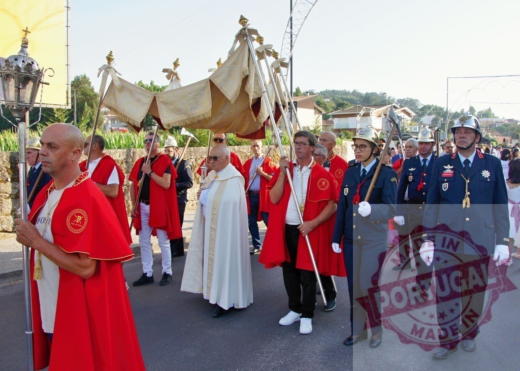 Religious procession walking down the street carrying a canopy | Procession 15.08.2025 - Assumption Day - Paco de Sousa, Portugal Catholic priests and firemen walking down the street during a religious procession, carrying a canopy - Realized with Pictrs.com