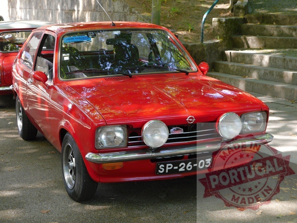 Red Opel Kadett GTE vintage car parked outdoors | Red Opel Kadett GTE vintage hatchback parked on an asphalt street with sunlight hitting the body - Realized with Pictrs.com
