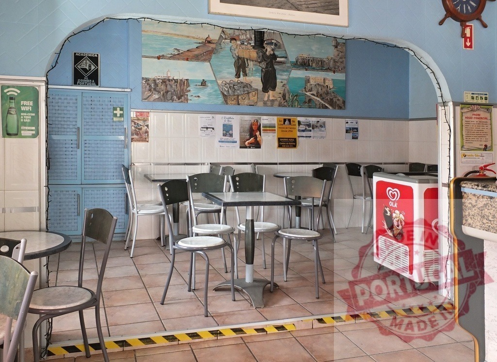 Old town cafe interior with nautical mural | Cafe interior featuring tables, chairs, and a large mural depicting nautical scenes - Realisiert mit Pictrs.com